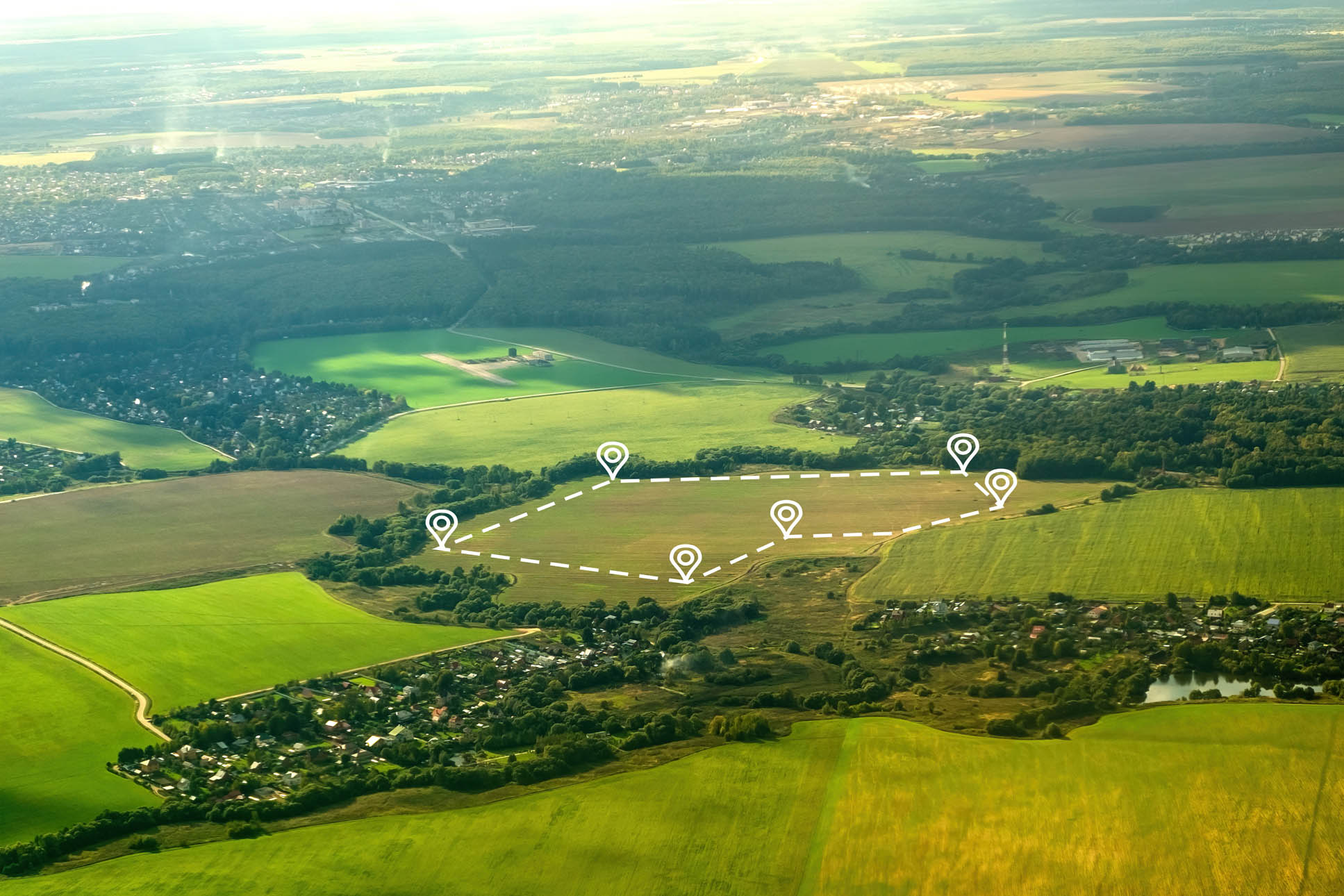 Aerial view of green field, position point and boundary line to